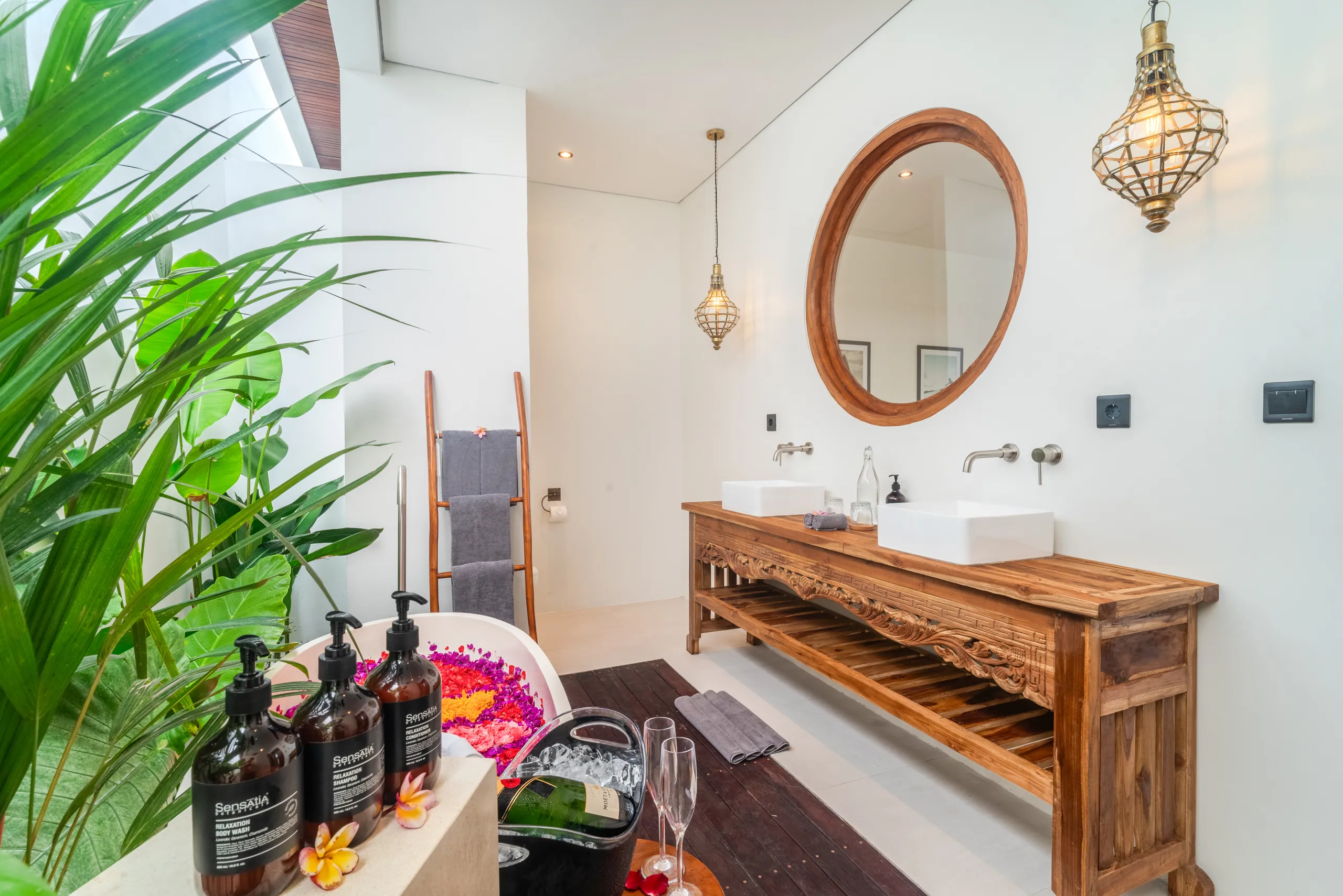 Bathroom detail with teak vanity, Aesop amenities and freestanding bathtub at Villa Sofra