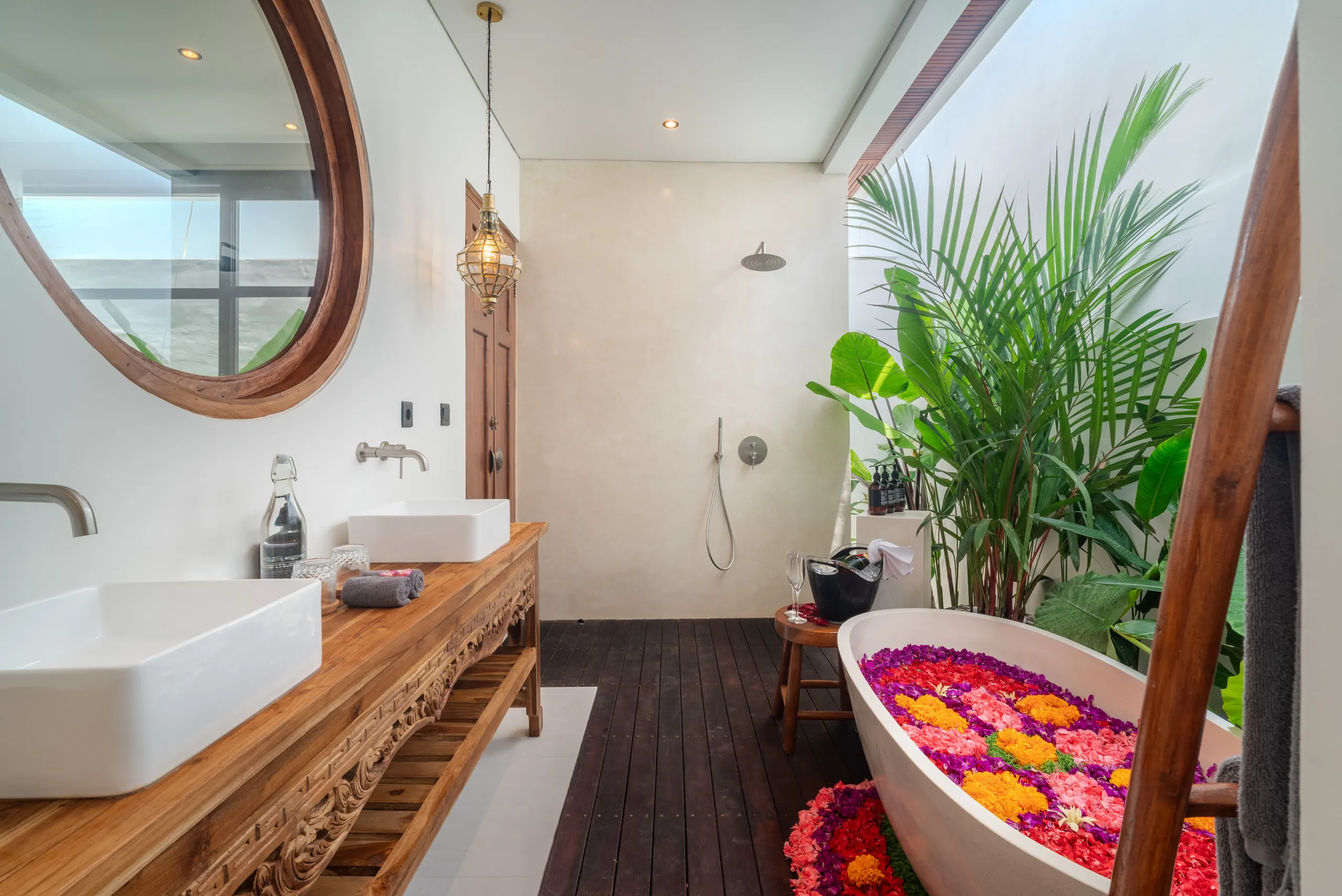 En-suite bathroom with outdoor shower area, freestanding bathtub and lush plants at Villa Sofra