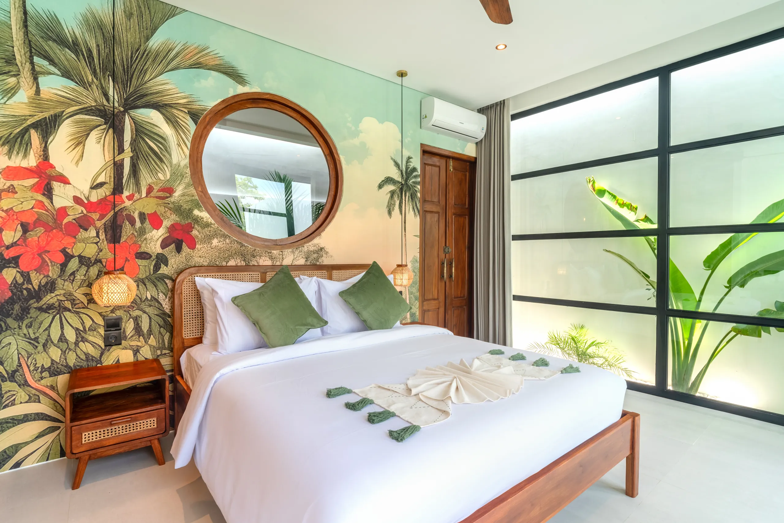 Master bedroom with tropical mural wallpaper and floor-to-ceiling windows at Villa Sofra