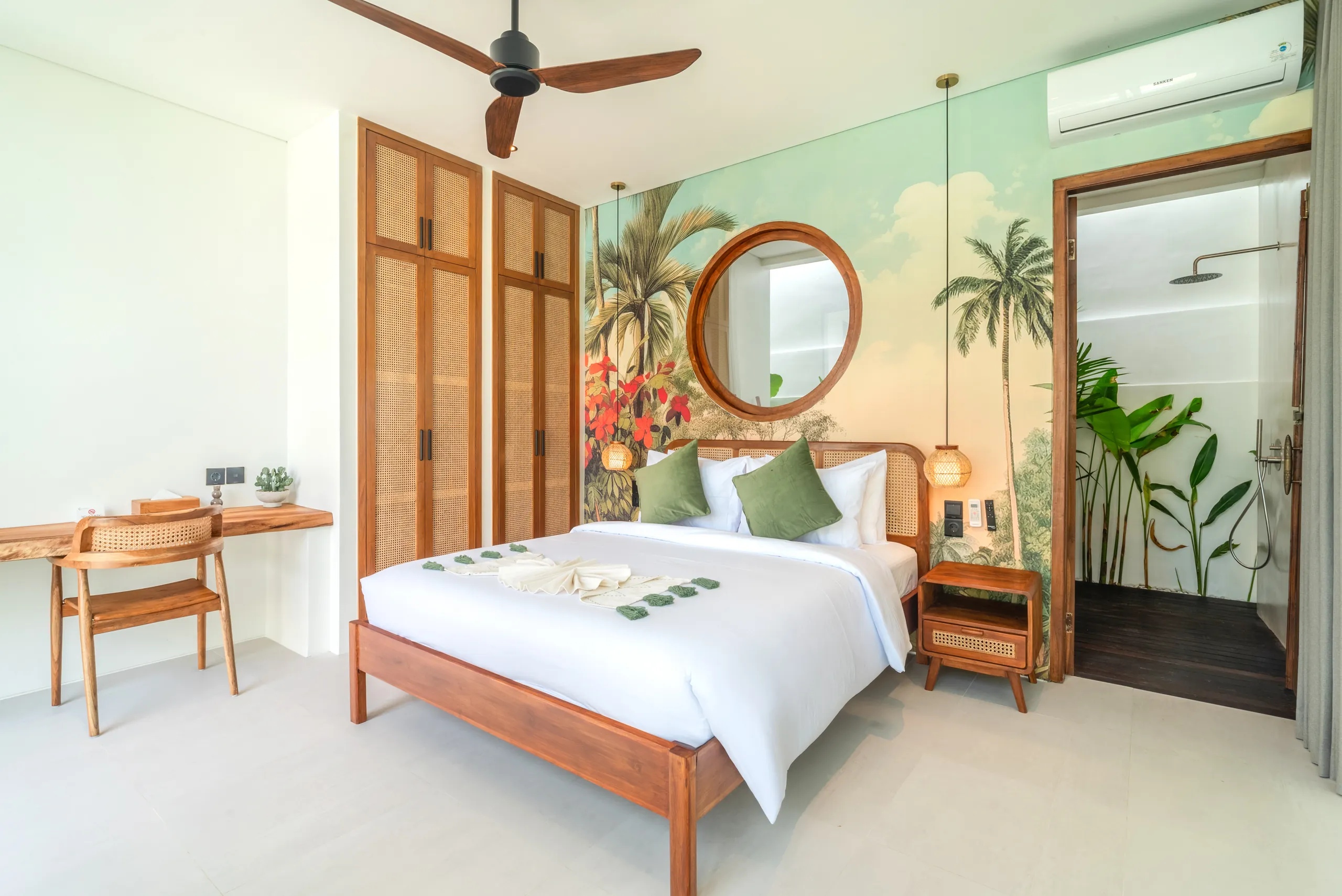 Bedroom with tropical mural, rattan wardrobe and en-suite bathroom at Villa Sofra