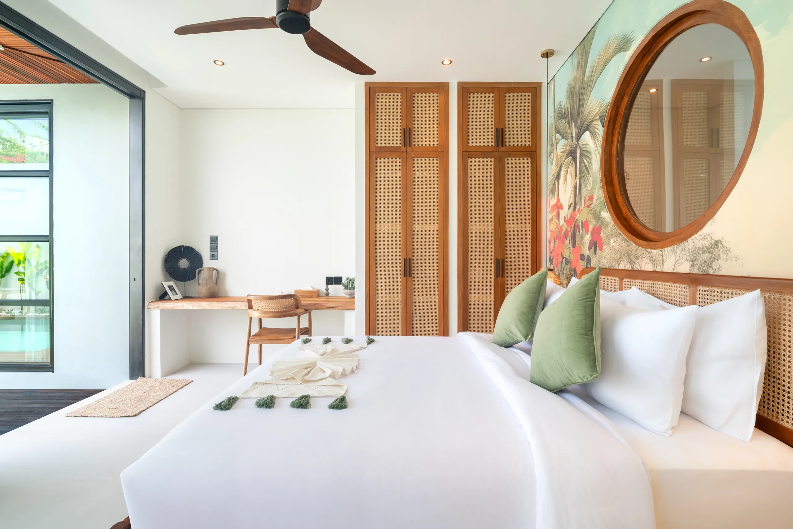 Bedroom with pool view through wide floor-to-ceiling glass windows at Villa Sofra