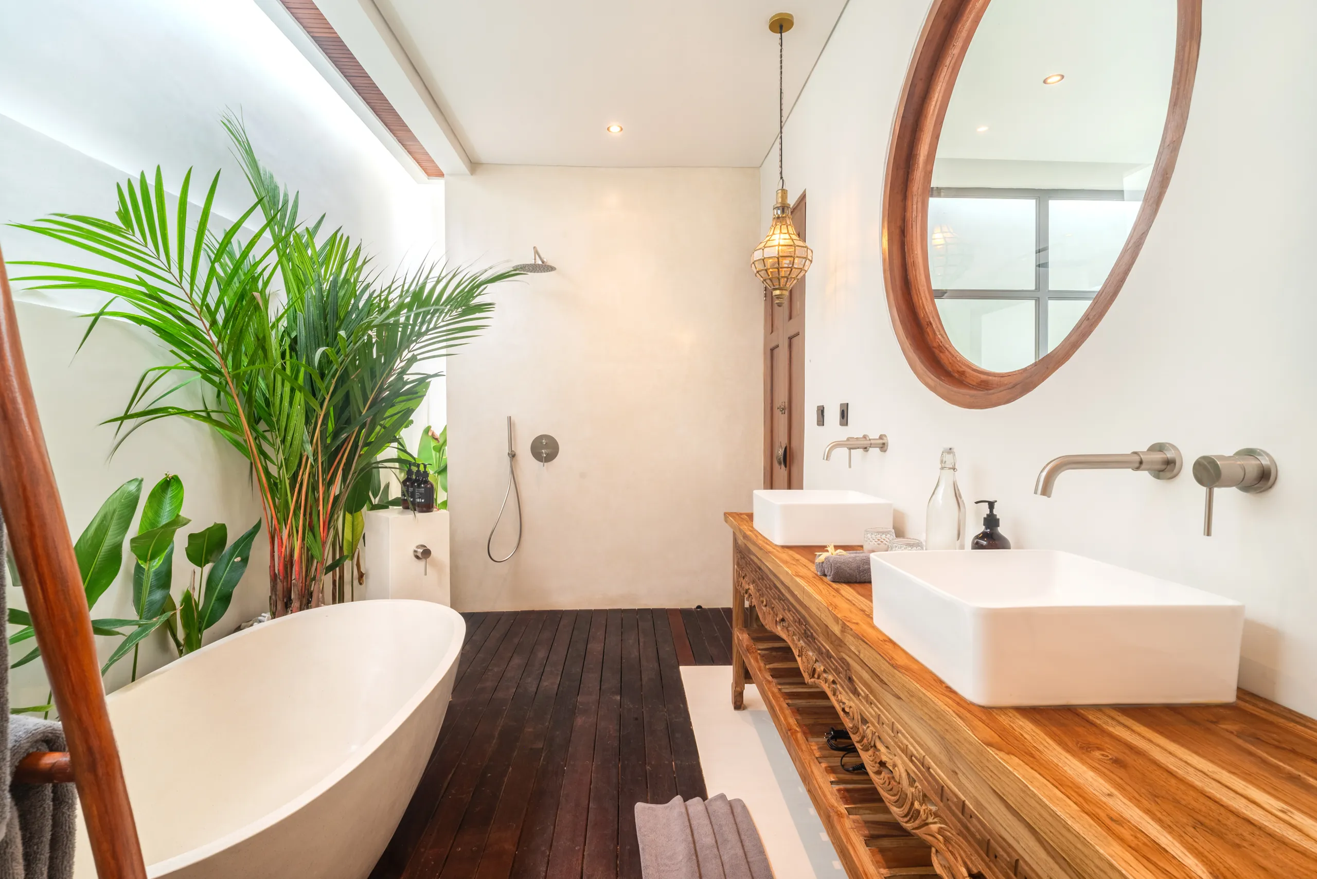 Bathroom with bathtub, teak vanity and open-air outdoor shower at Villa Sofra