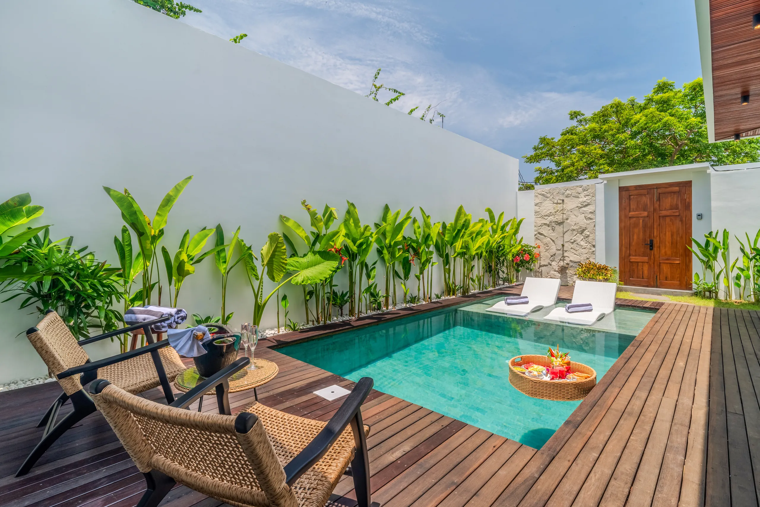 Private pool with teak deck, sun loungers and floating breakfast tray at Villa Sofra Bingin