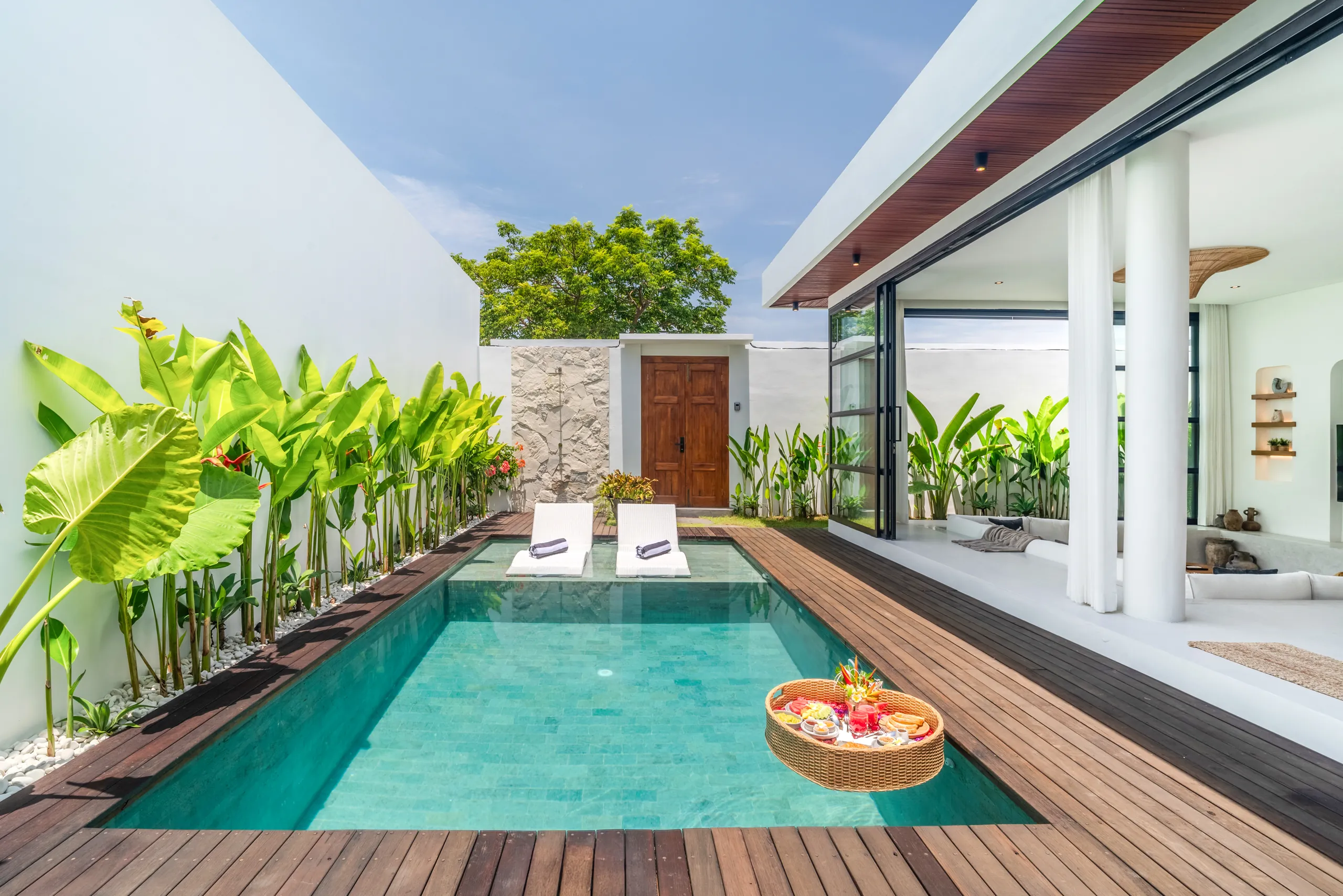 Private pool with sun loungers and floating breakfast tray in afternoon light at Villa Sofra