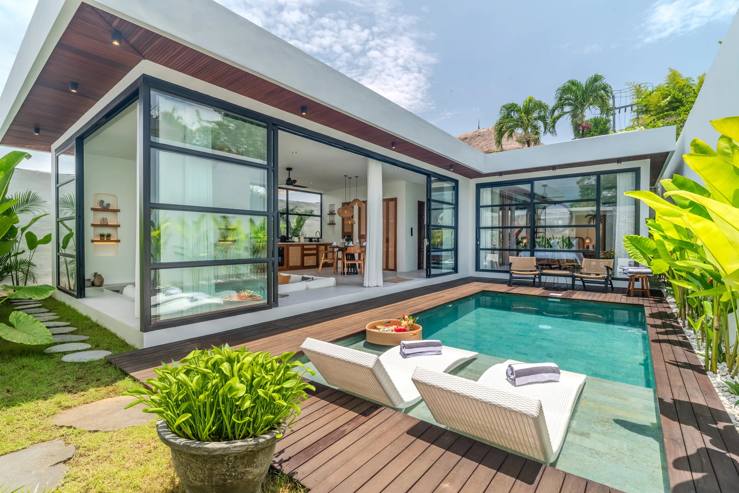 Villa entrance with stone feature wall and carved teak double doors at Villa Sofra