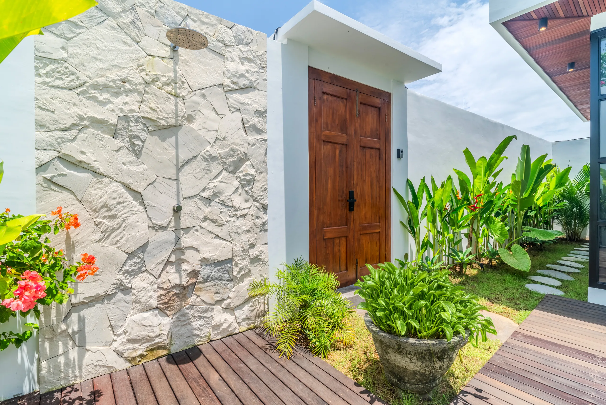 Sunken living area with Smart TV, open kitchen and tropical garden views at Villa Sofra