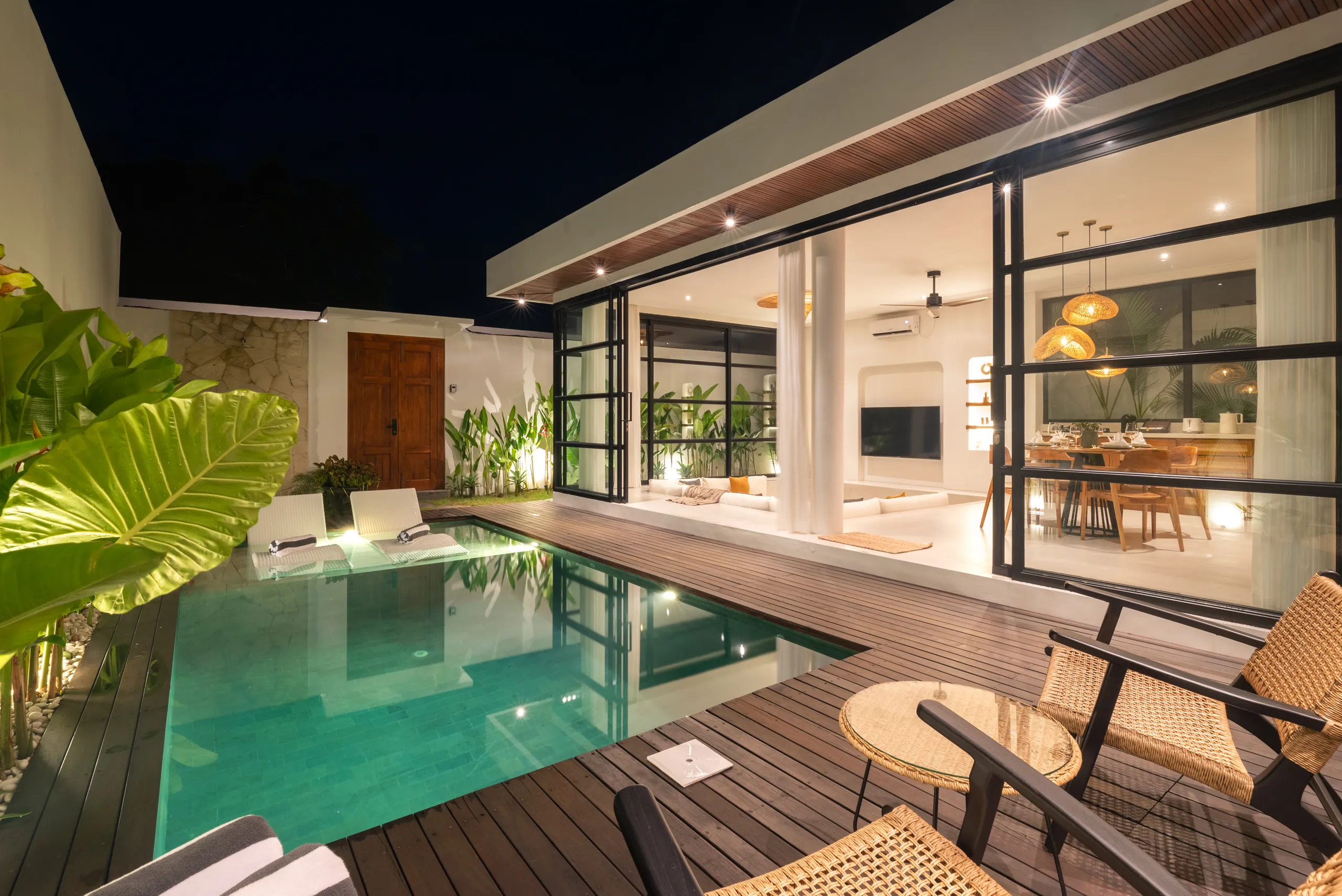 Private pool at night with sun loungers partially in the water at Villa Sofra