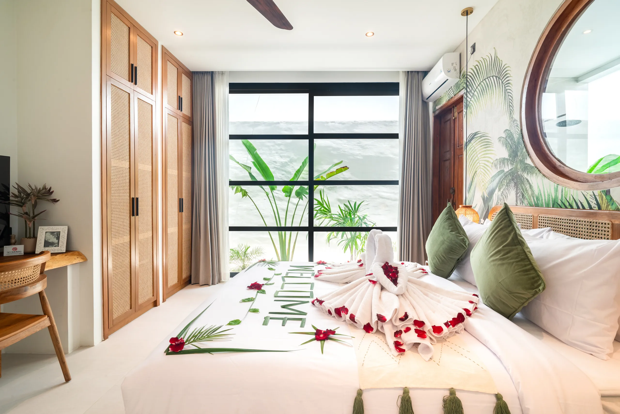 Master bedroom with tropical mural and semi-outdoor en-suite bathroom at Villa Sofra